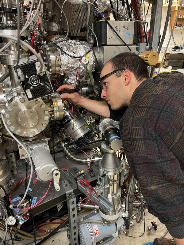 Picture of Bobby preparing to load a sample for ion beam exposure.