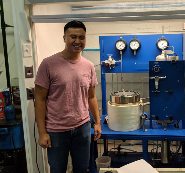 Image of Kevin evaluating a supercritical drier that he designed for producing aerogels at JPL