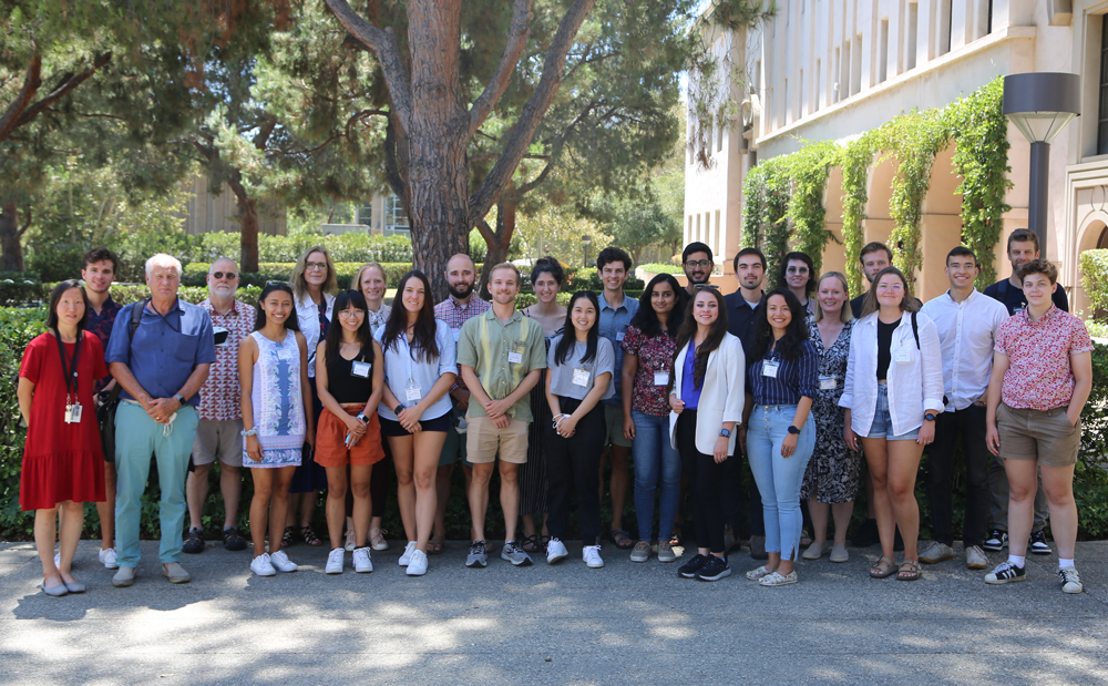Image of NASA Summer School students in front of a hedge