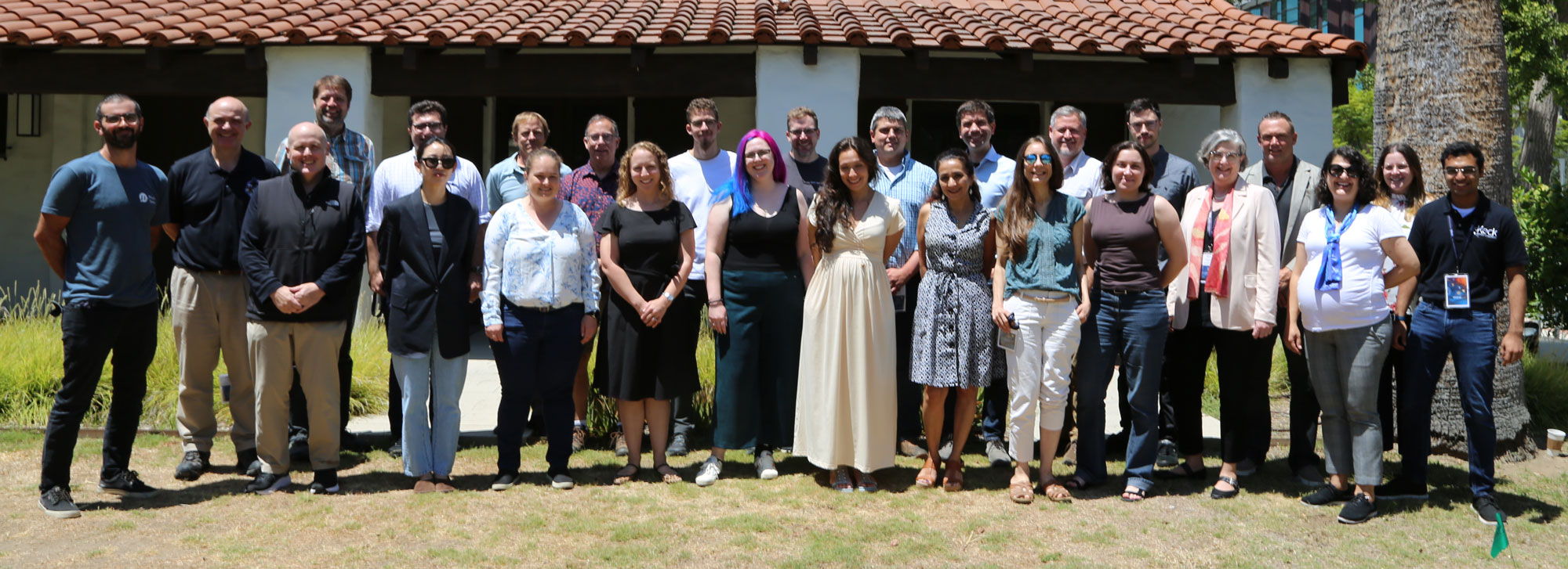 symposium group in front of Tolman/Bacher House
