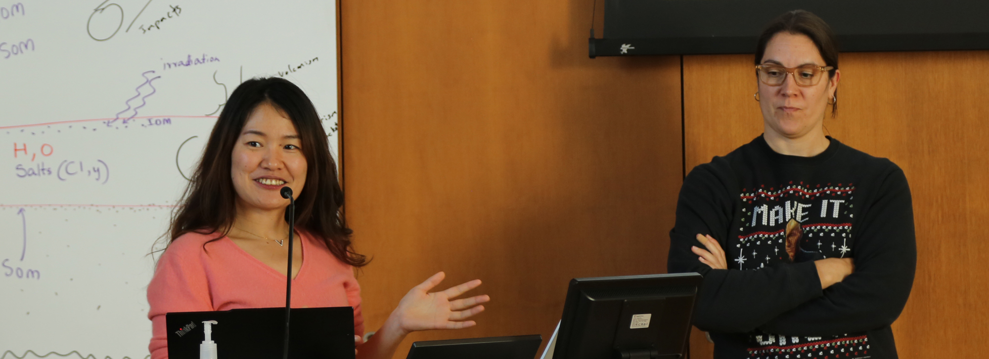 two people presenting at podium
