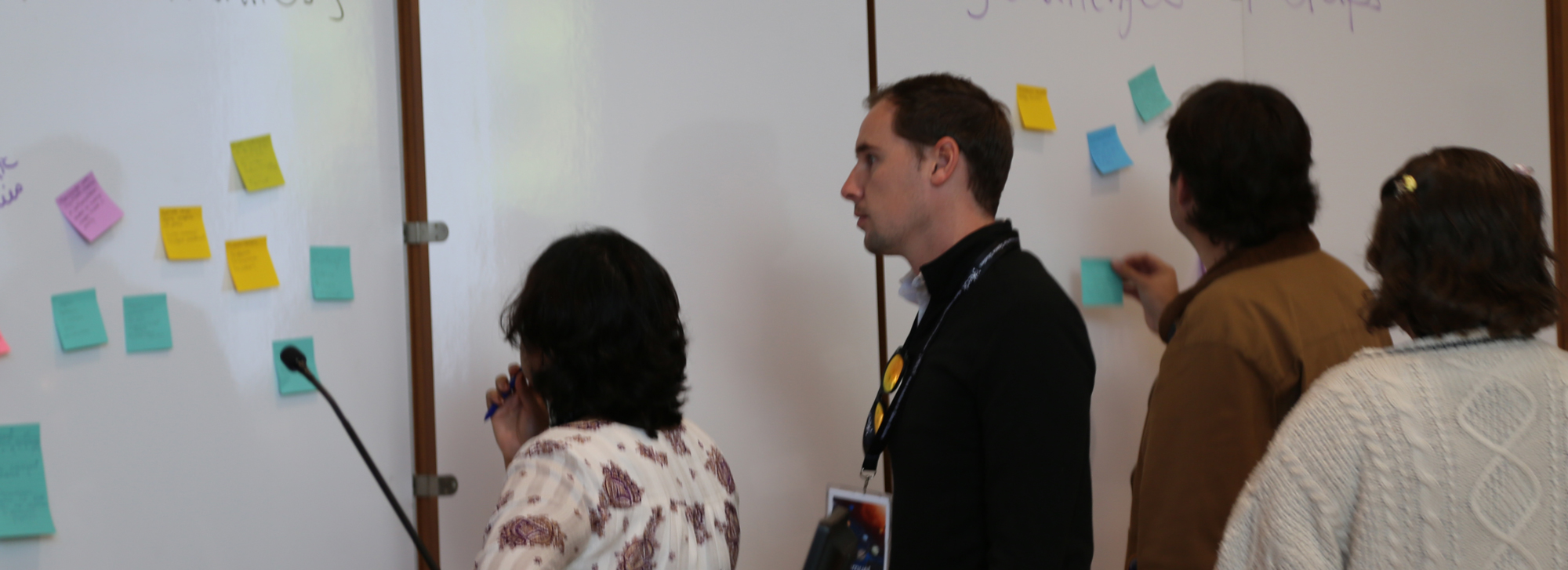study participants discussing near whiteboard