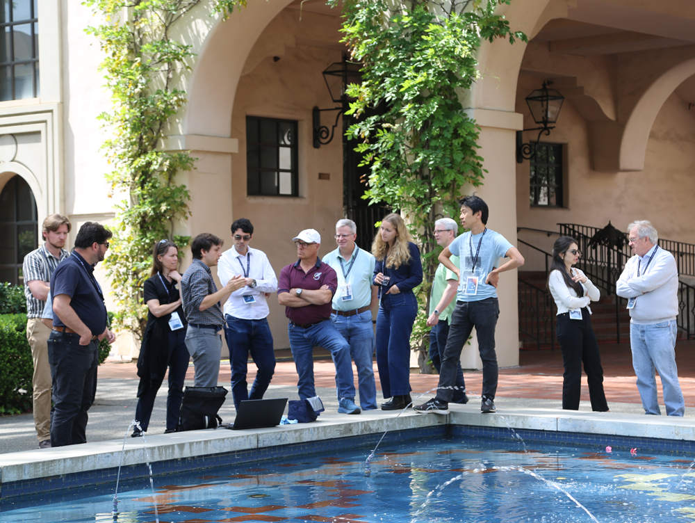 participants around a fountain as small robots swim